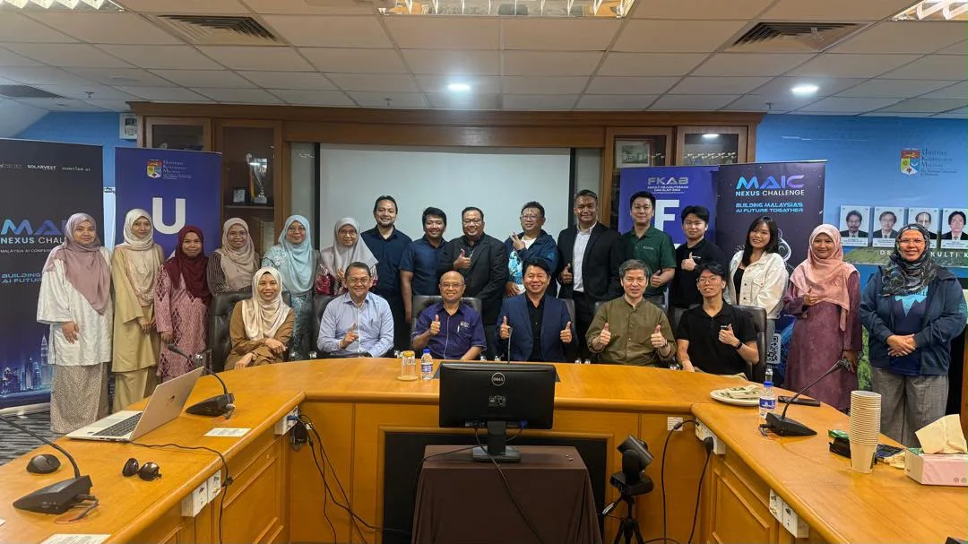 MAIC roadshow participants and university hosts giving a thumbs up around a meeting-room table